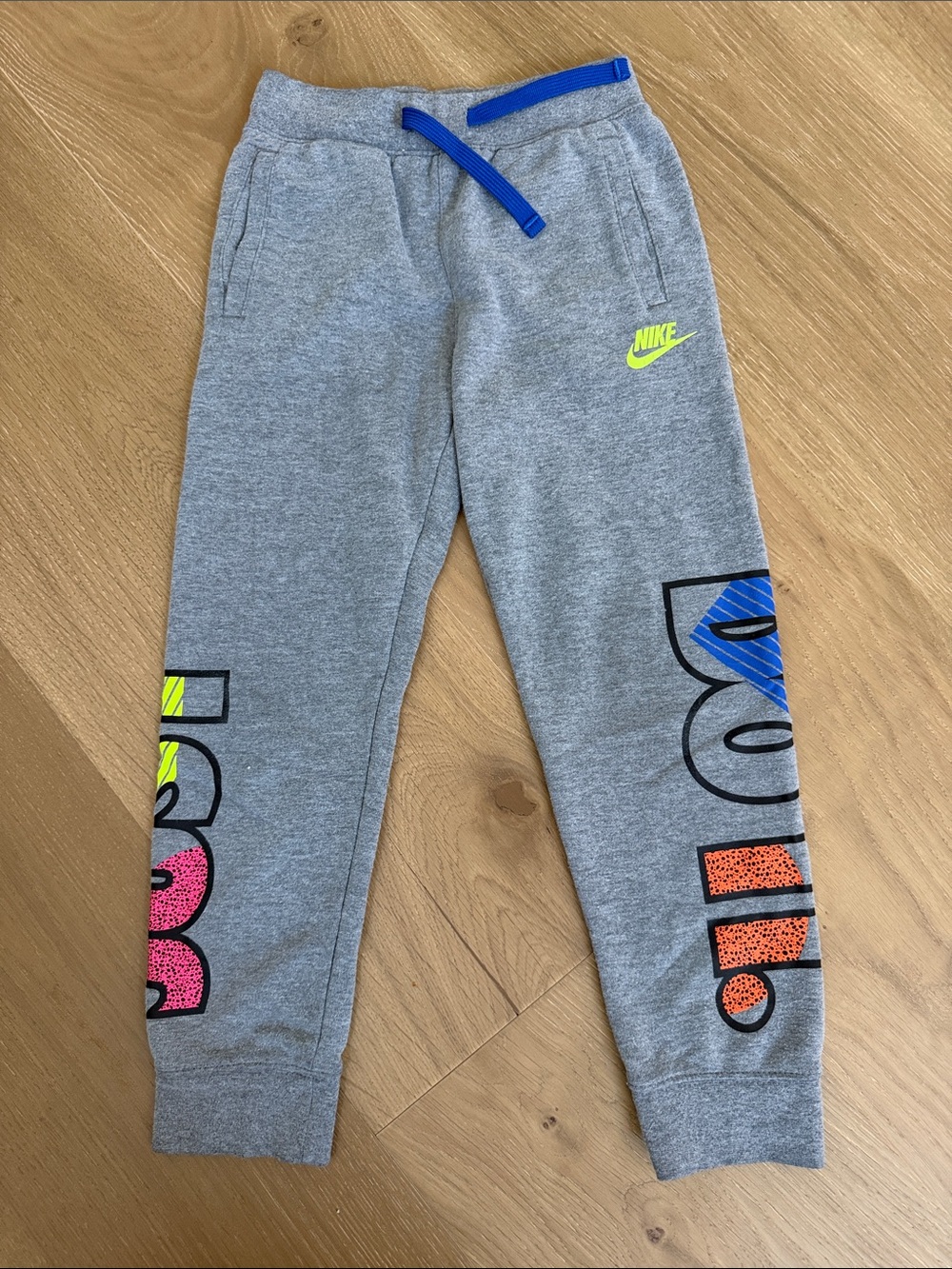 Nike Kids Gray Joggers with Neon Yellow Logo and Blue Drawstring